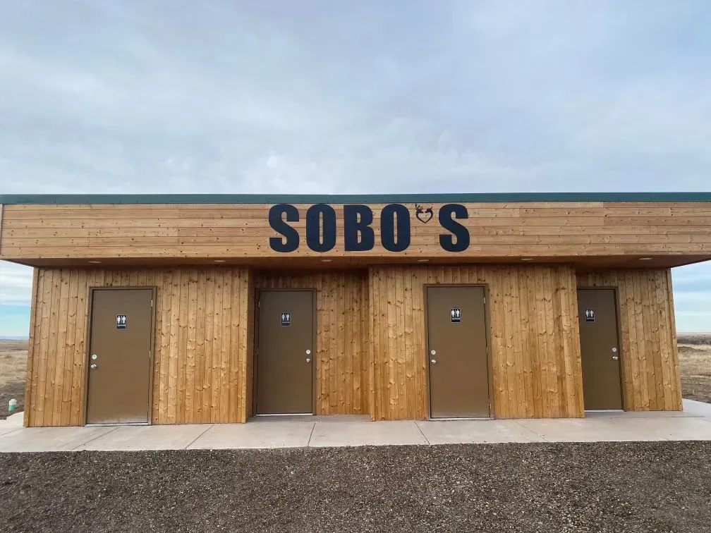 SOBO's Campground bathhouse featuring clean private restrooms and showers with modern rustic wood exterior near the Badlands of South Dakota.