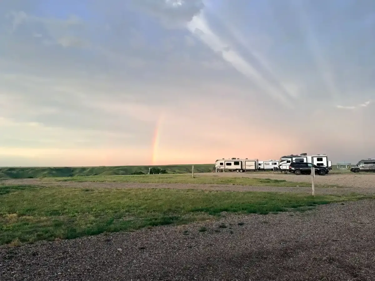 Rainbow forming above the Badlands and RV campsites at SOBO's Campground after a passing storm.