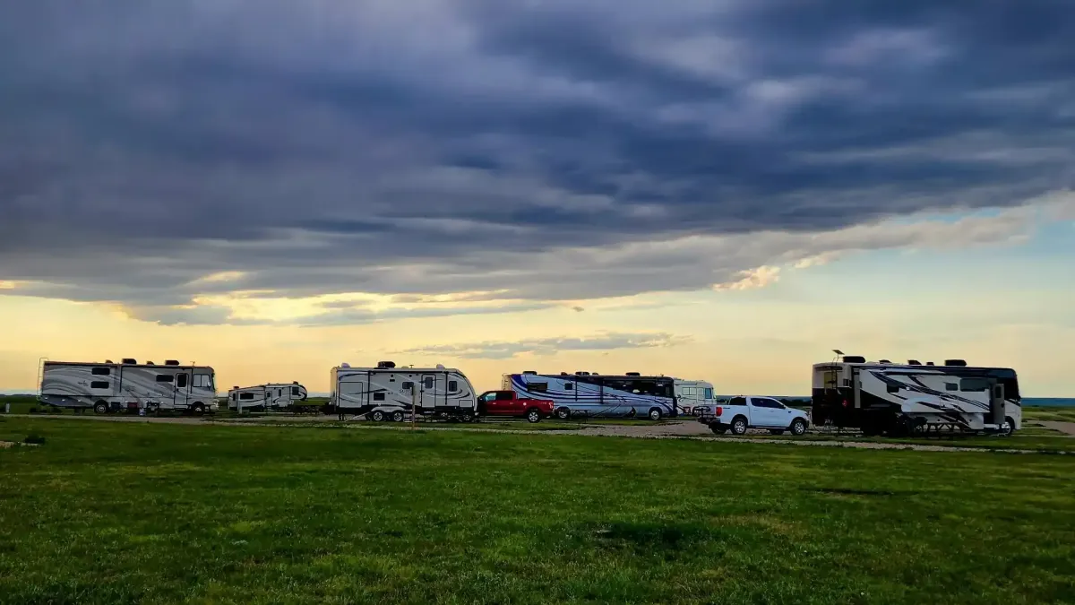 Dramatic storm clouds rolling over RV campers enjoying the peaceful scenery at SOBO's Campground.