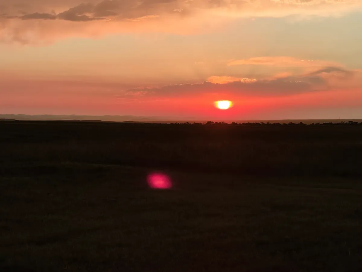 Brilliant red prairie sunset over the South Dakota horizon near SOBO's Campground.