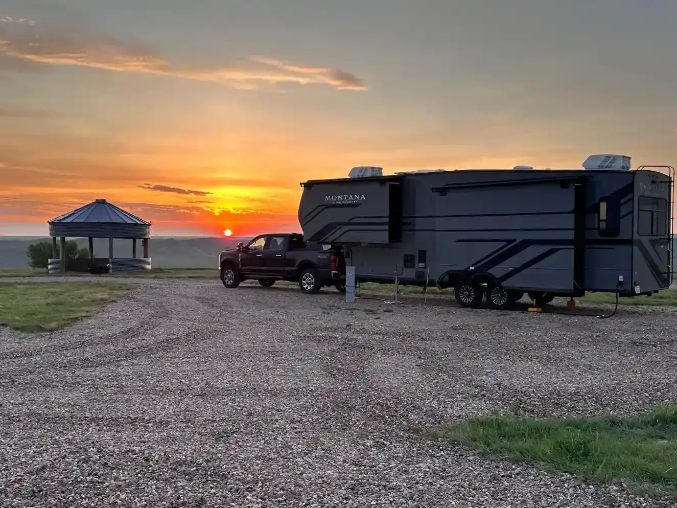 Sunrise over an RV campsite with Badlands views at SOBO's Campground in Scenic, South Dakota.