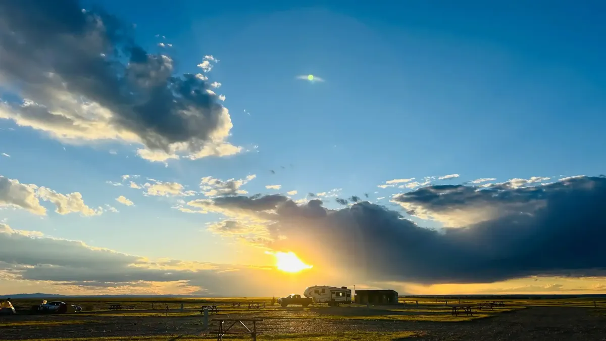 Dramatic sunset with storm clouds over the Badlands landscape viewed from SOBO's Campground.