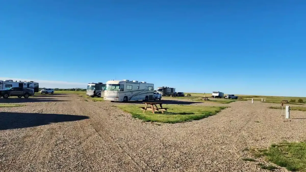 Spacious full hookup RV campsites with picnic tables and wide-open prairie views at SOBO's Campground near Badlands National Park.