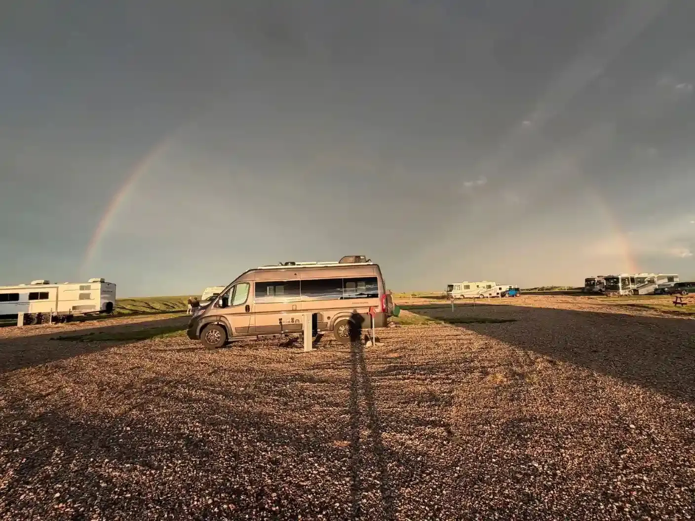 Double rainbow stretching across the sky above RV campsites at SOBO's Campground after a summer rainstorm.
