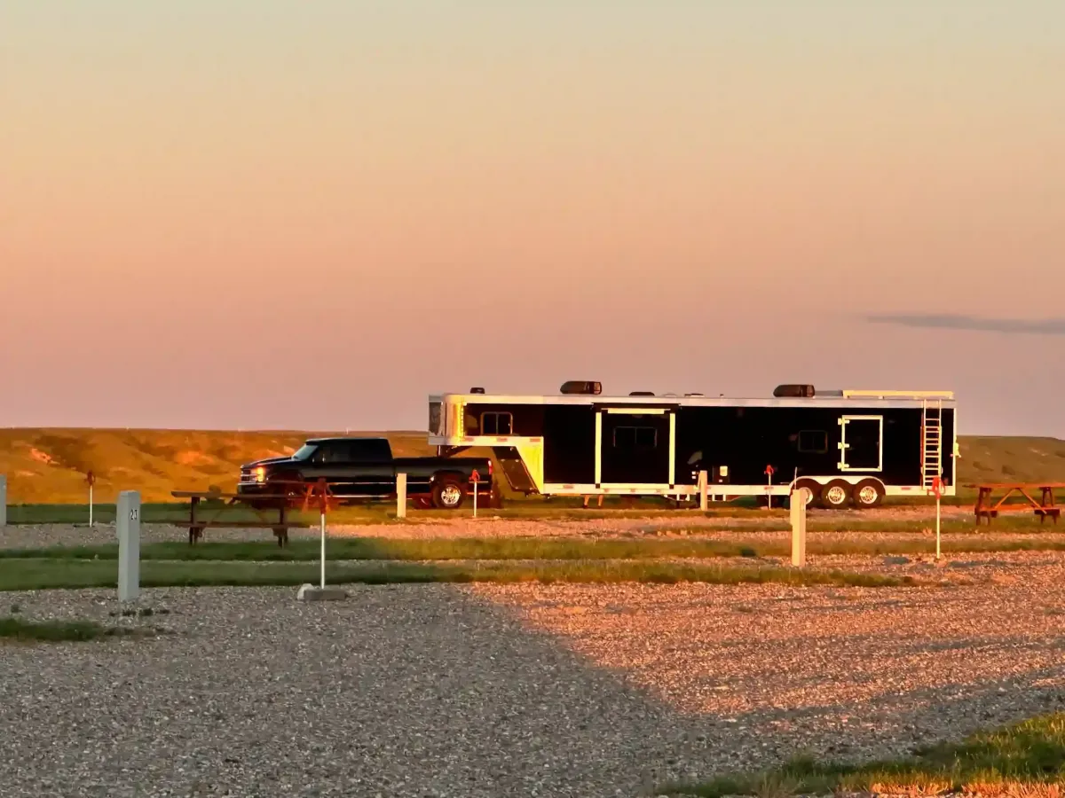 RV campsite glowing during golden hour with beautiful prairie sunset views at SOBO's Campground.