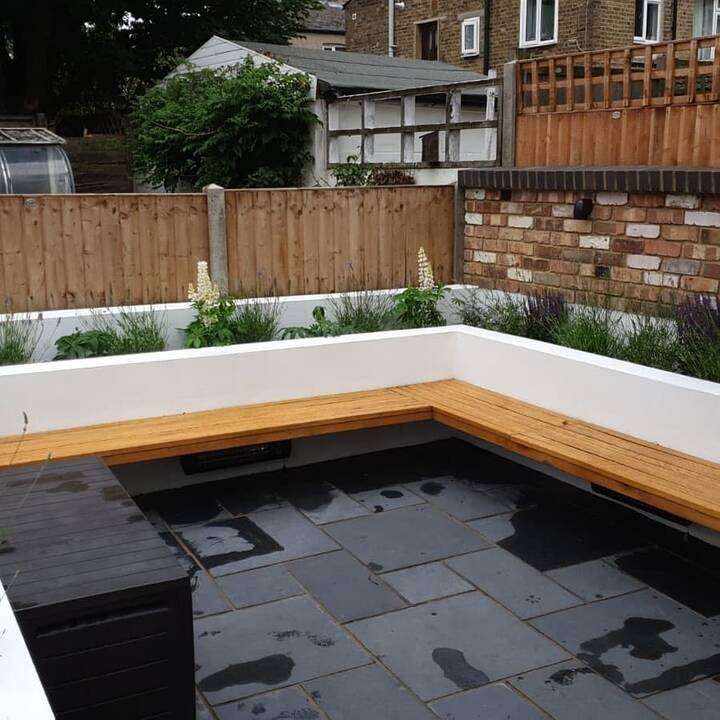 Vertical close-board fencing installation against existing brick wall in Fulham