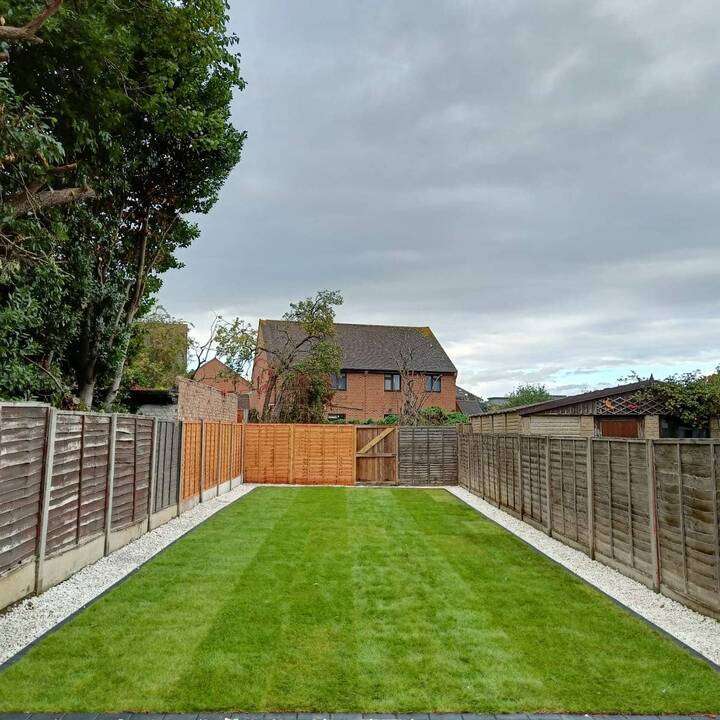Artificial grass garden with mature palm tree and sand base ready for laying in Pinner