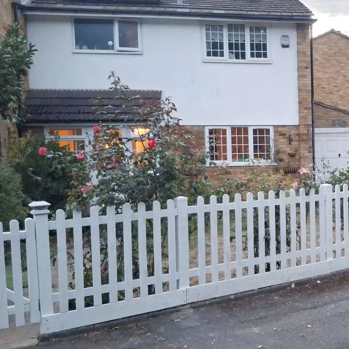 New white picket fence installed along a front garden in West London