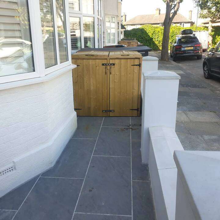 Front door entrance with grey slate paving and decorative cobblestone border edging in Fulham