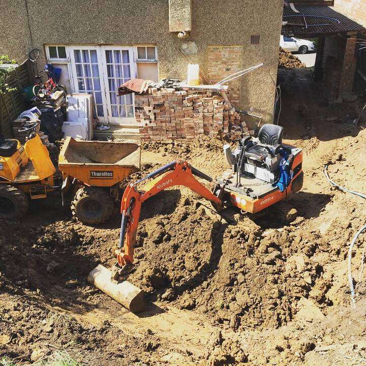 Mini Kubota digger fitted with auger attachment for fence post groundworks in Beaconsfield