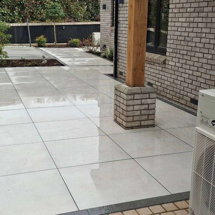 Completed natural stone patio installation across rear courtyard in Uxbridge