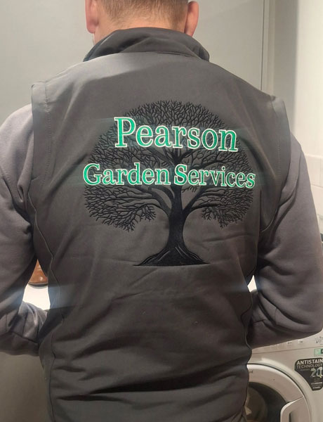 Pearson Garden Services worker wearing a company branded jacket