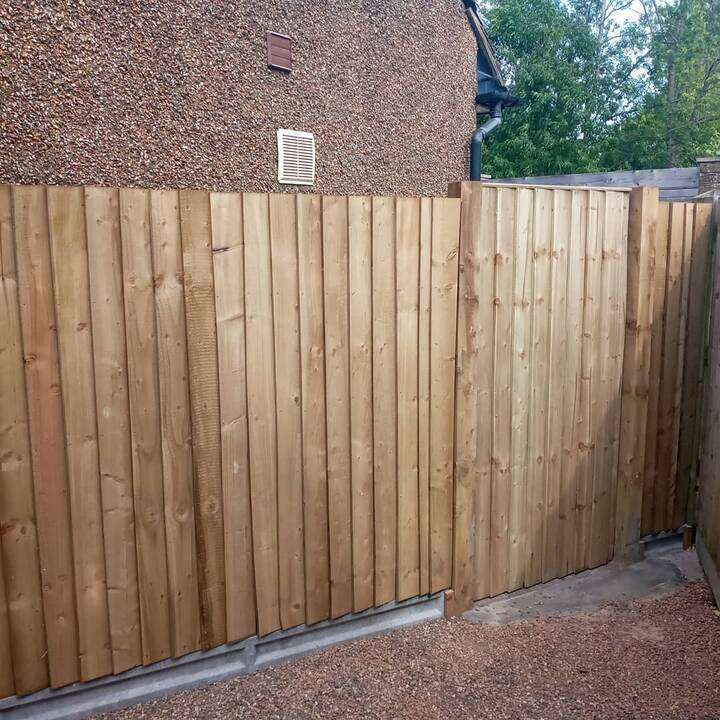 New close-board garden fencing with concrete posts and gravel boards in Ealing