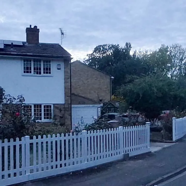White picket fencing around the corner of a front garden