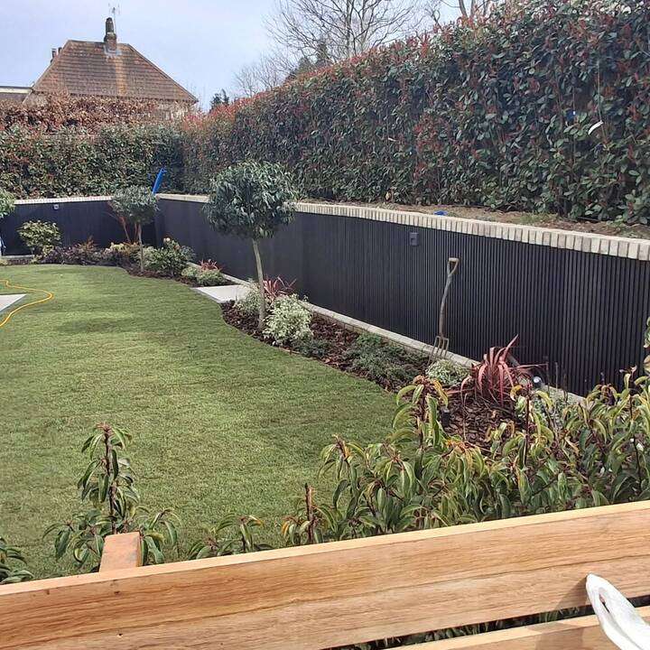Front garden turfing in progress with lawn rolling and prepared base in Ruislip