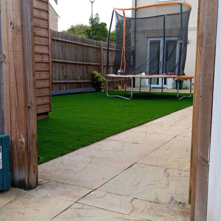 Rendered raised planters with hardwood bench seating and slate patio in Chiswick