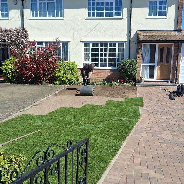 Tiered artificial grass installation with brick retaining walls and stone steps in Pinner