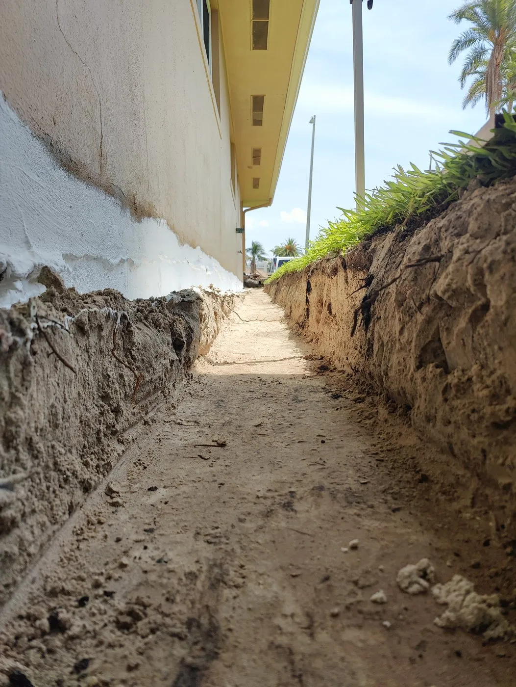 Deep foundation drain trench with the rubberized waterproofing coating applied to the wall