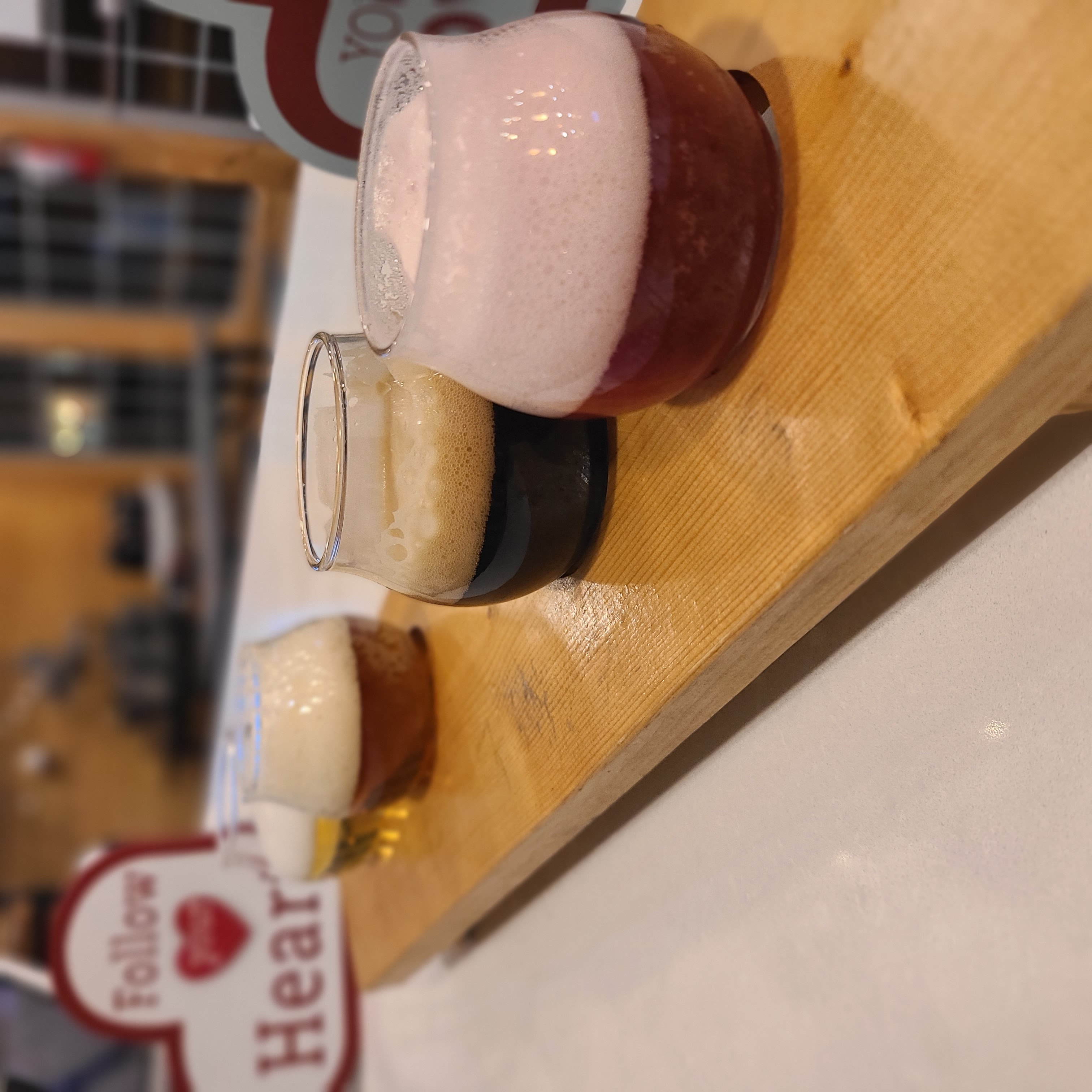 Pint of amber craft beer and grill-fired dish on rustic table at 2ndWind