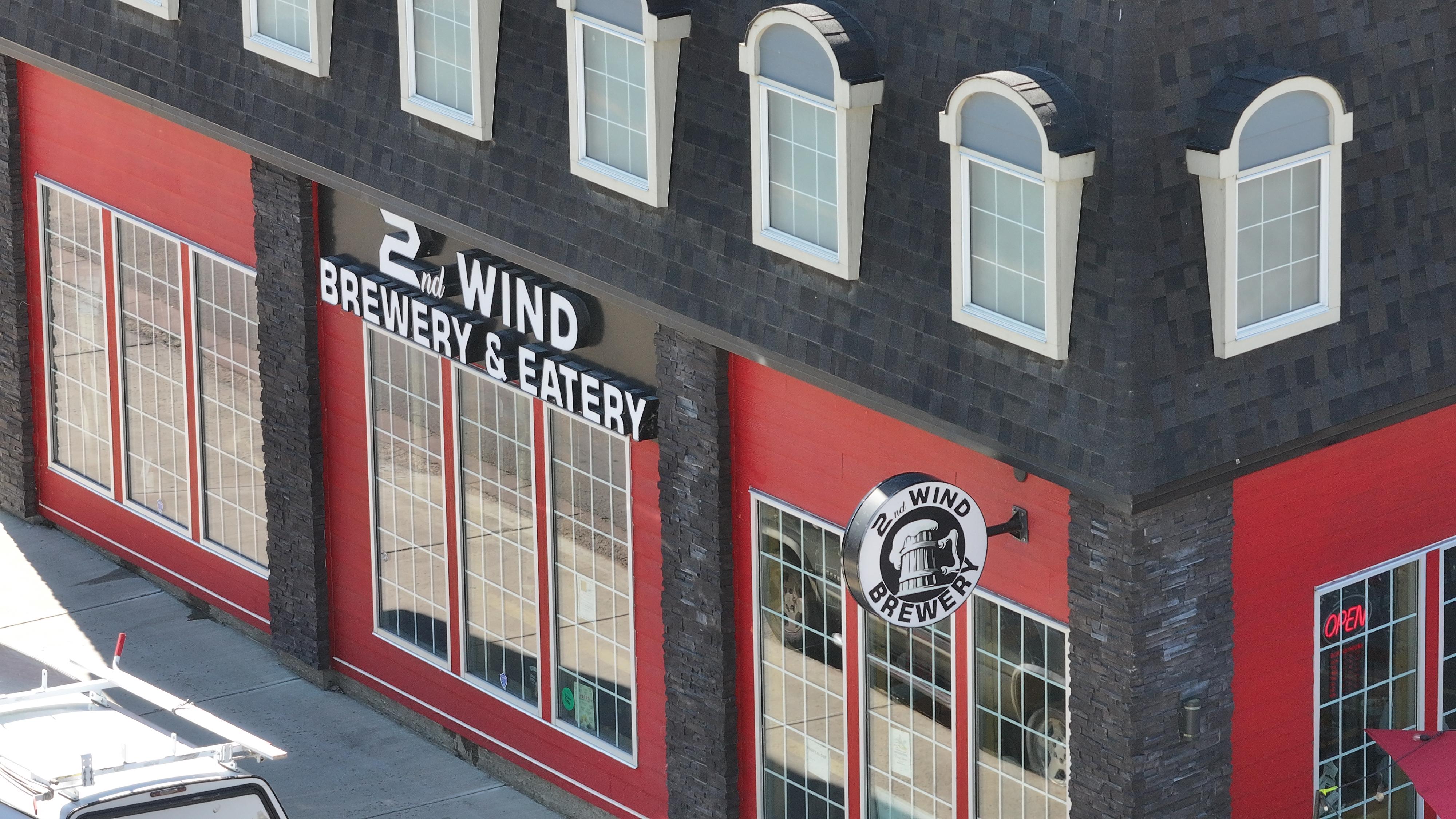 Cozy interior of 2ndWind Brewery with copper tanks and warm lighting