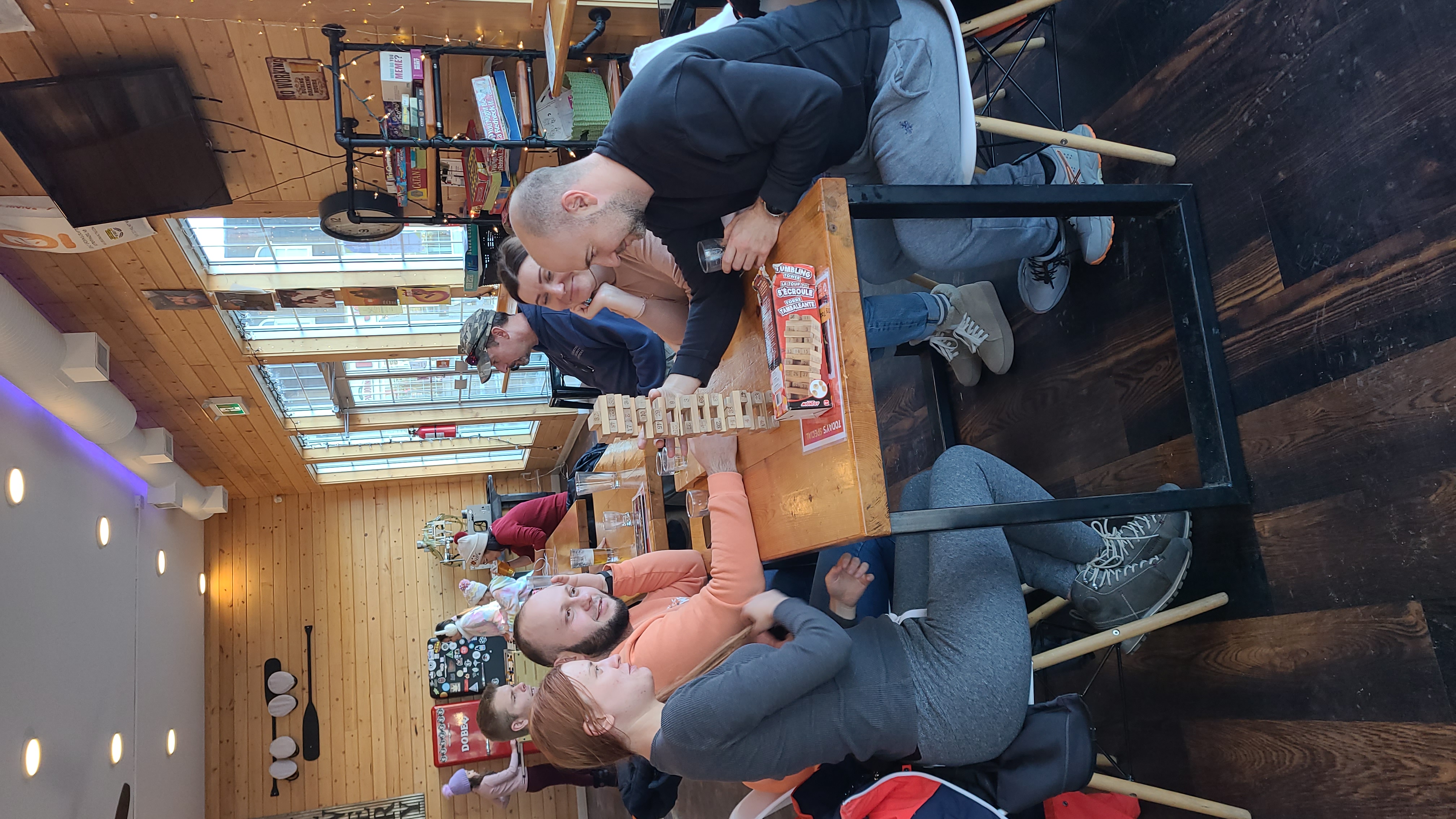 Guests playing patio games during an evening event at 2nd Wind Brewery and Eatery