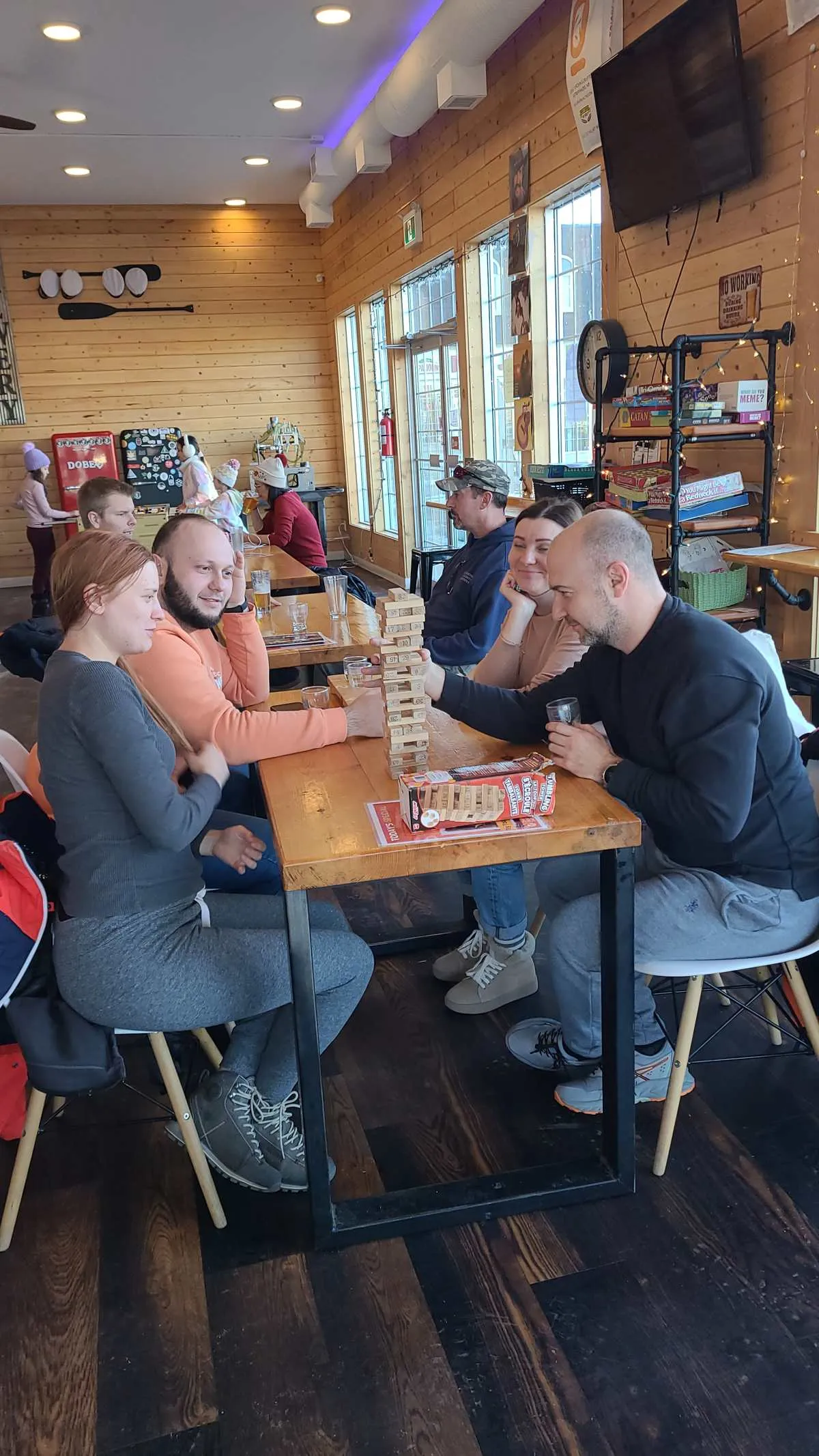 Guests playing patio games during an evening event at 2nd Wind Brewery and Eatery