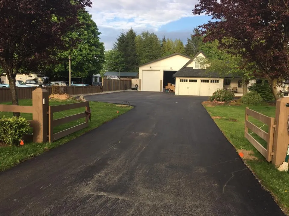 Residential driveway freshly paved by our asphalt contractors, offering smooth and durable asphalt paving.