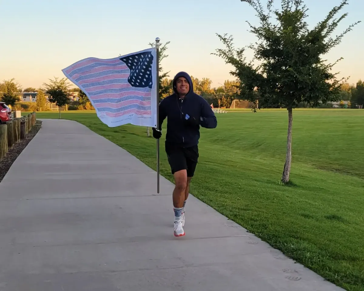 Runner carrying the Flag of Honor during 9/11 tribute
