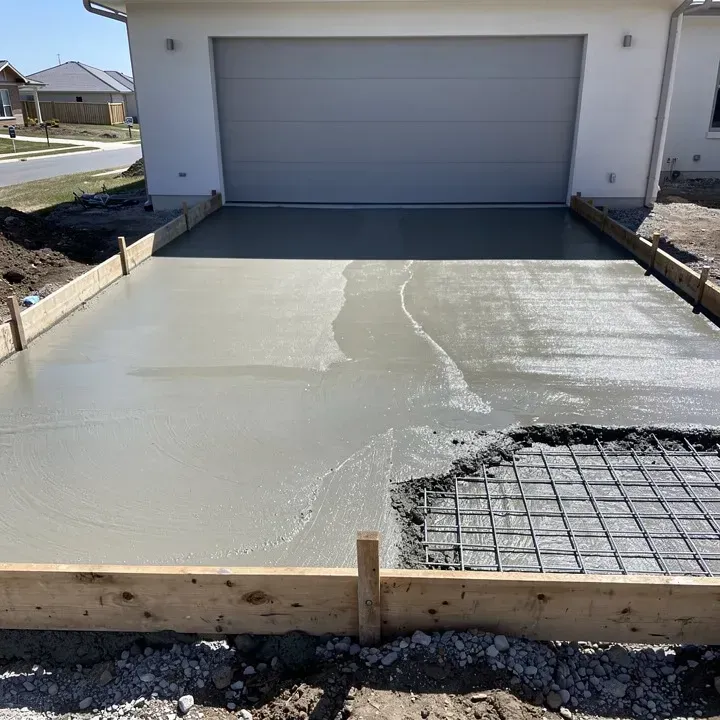 Concrete driveway under construction with form boards and wet concrete in Ashland, Oregon