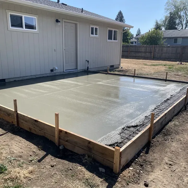 Concrete patio under construction with form boards attached to a home in Ashland, Oregon