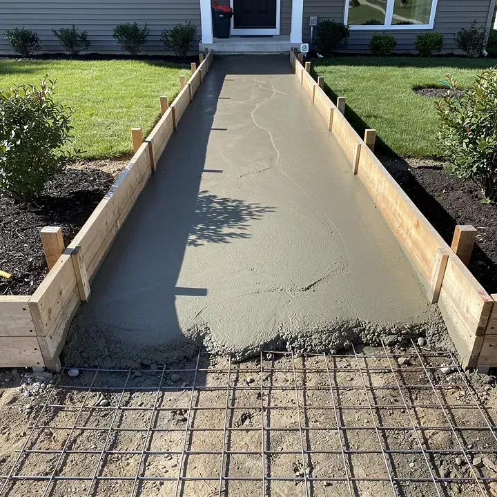 Concrete sidewalk under construction with wooden form boards in Ashland, Oregon