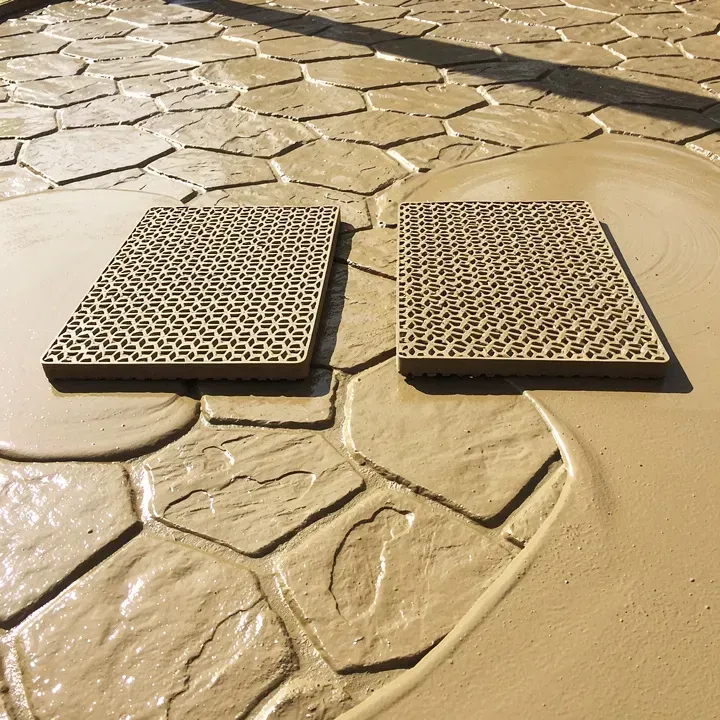Two stamping mats laid on freshly poured wet concrete creating a stone pattern in Ashland, Oregon
