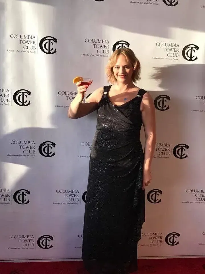 Confident female coach portrait, photorealistic, on dark background