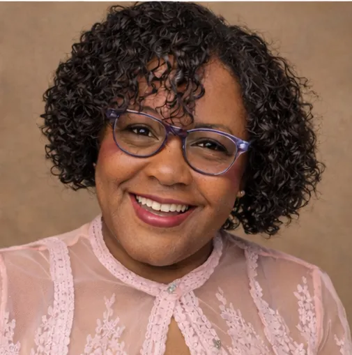 Headshot avatar of a smiling 30-something woman