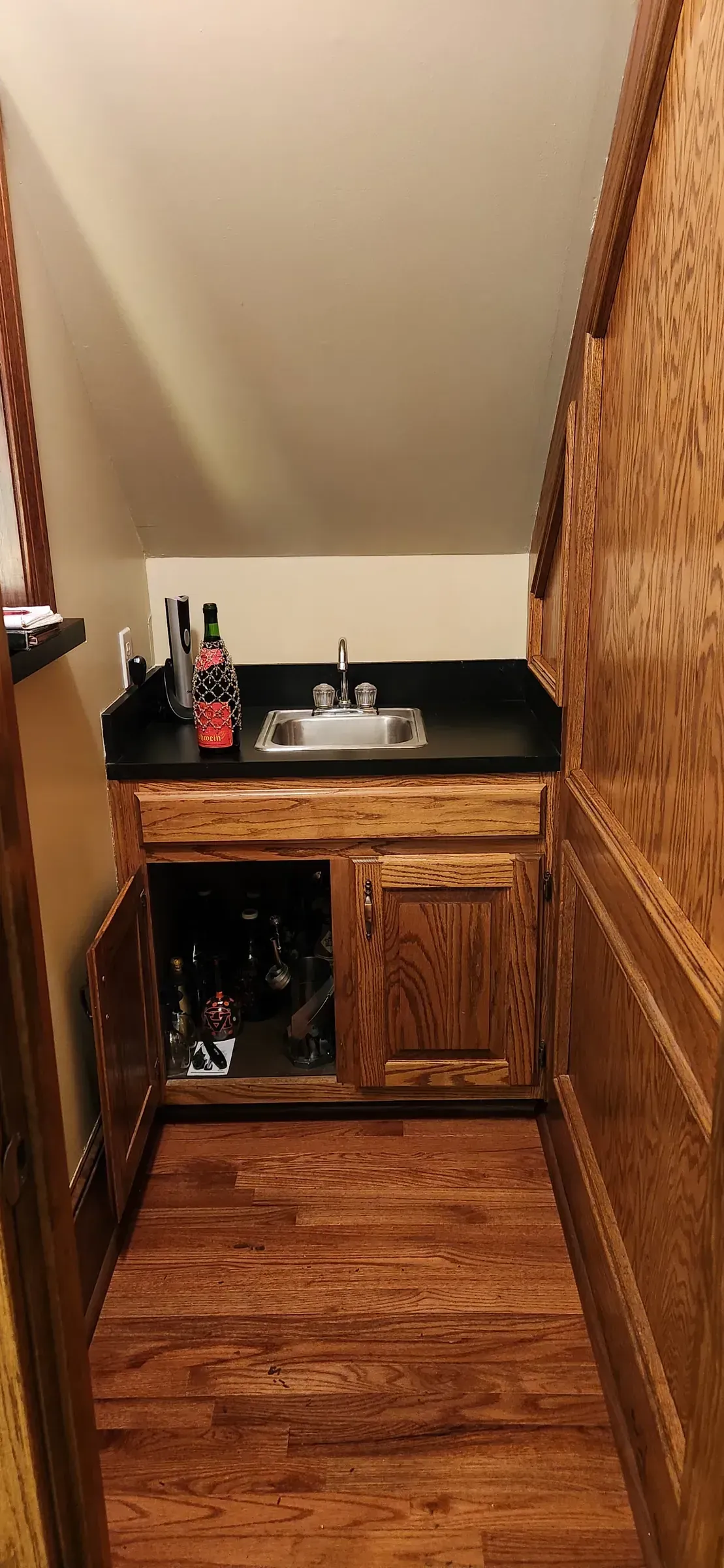Dated 1980s oak wet bar with laminate counter before renovation