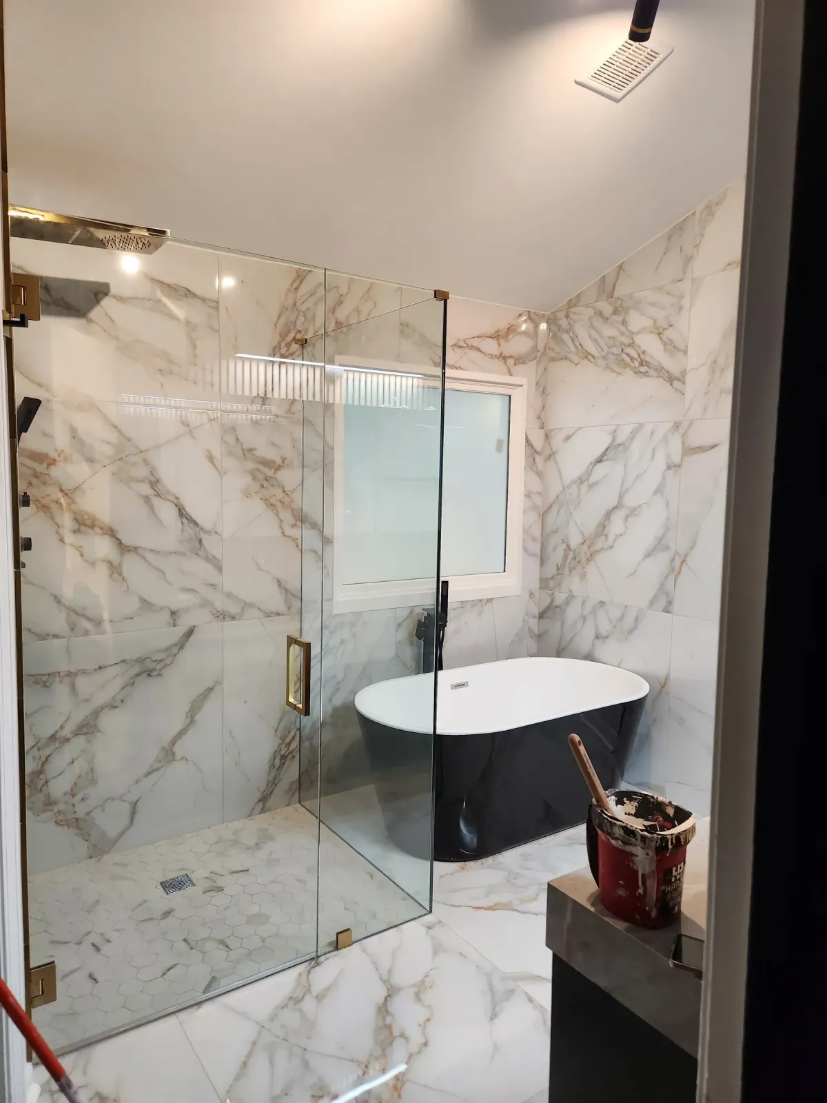 Finished custom primary bath with slab walls and floating vanity