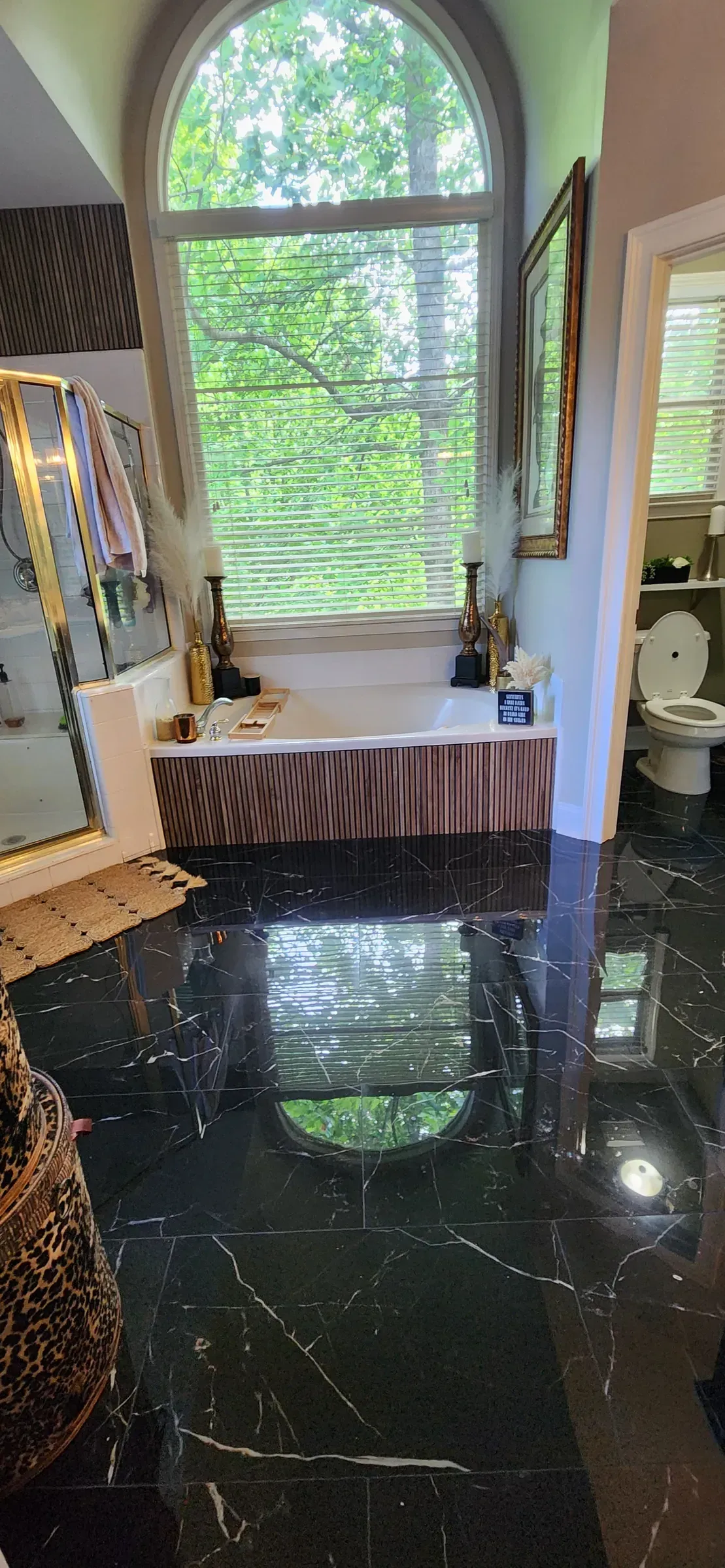 Black marble floor. Polished, level, and reflective enough to show any mistake