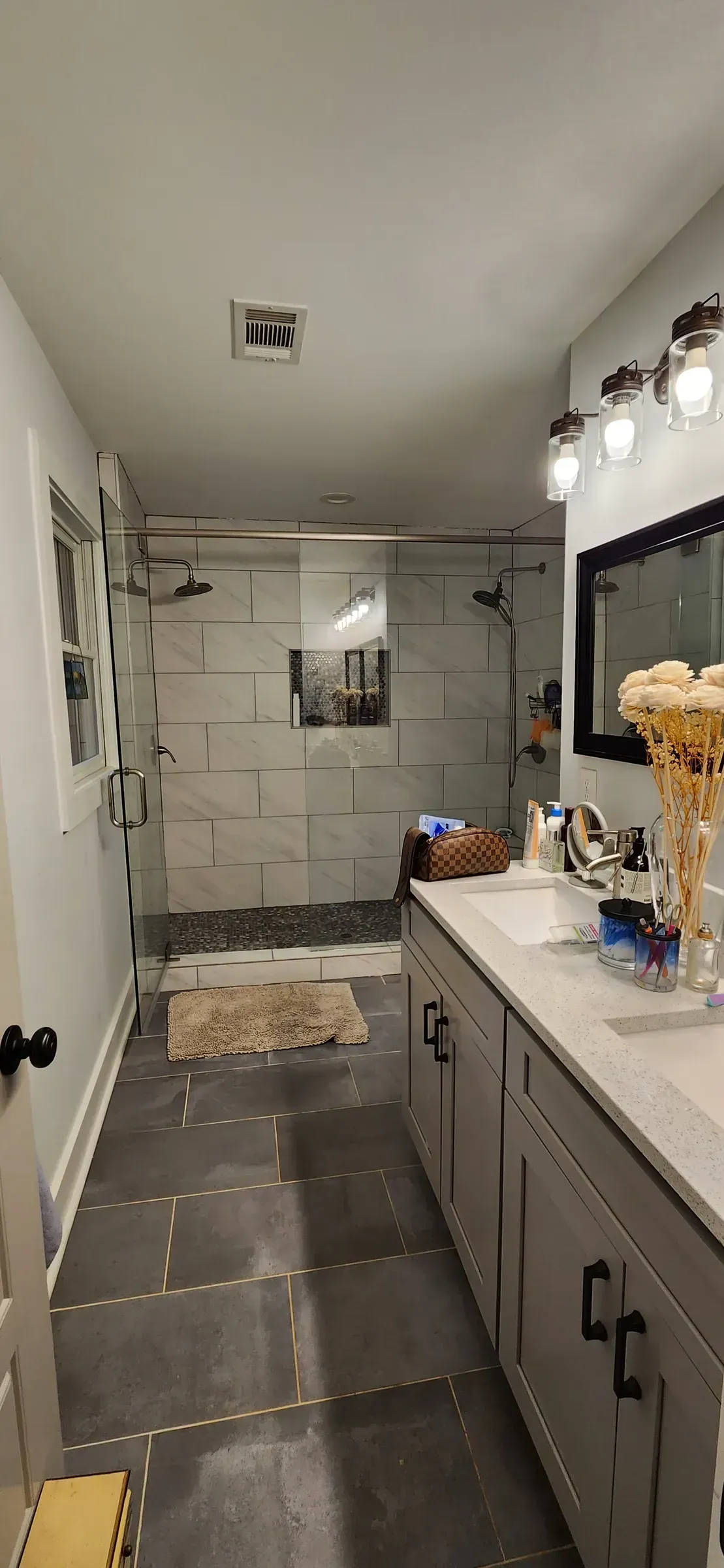 Finished walk-in shower with rainhead and twin mirrors
