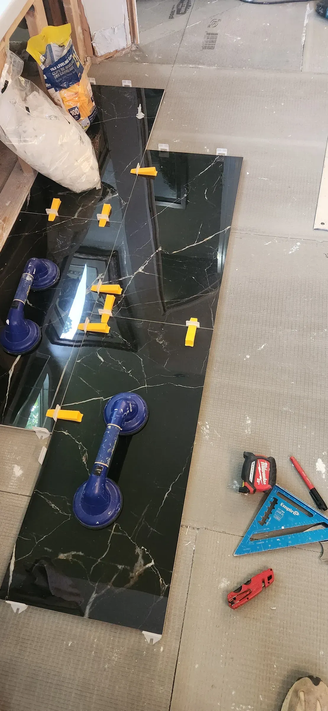 Large format tile slab set with suction cup handles