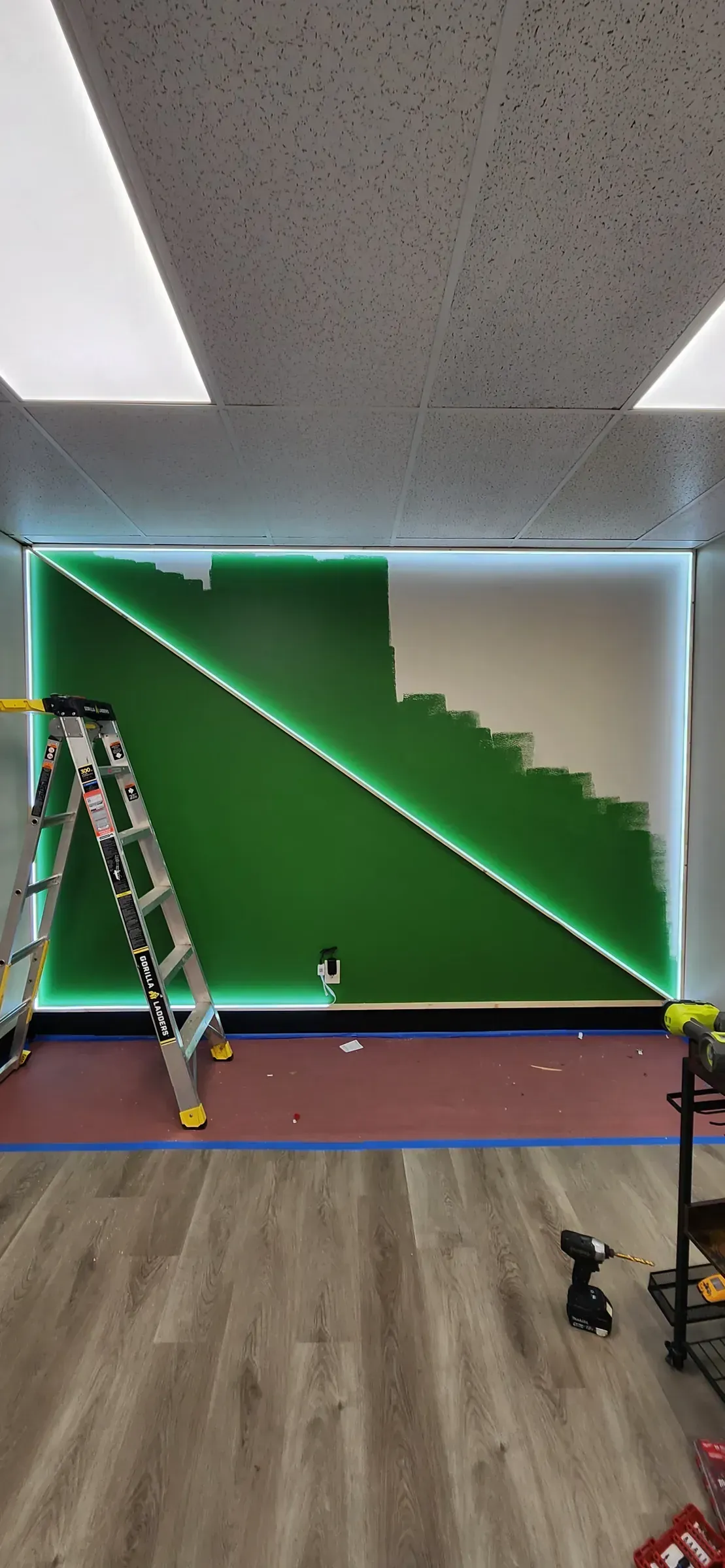 LED-backlit accent wall. Stair-step diagonal, fabricated on site, lit from behind