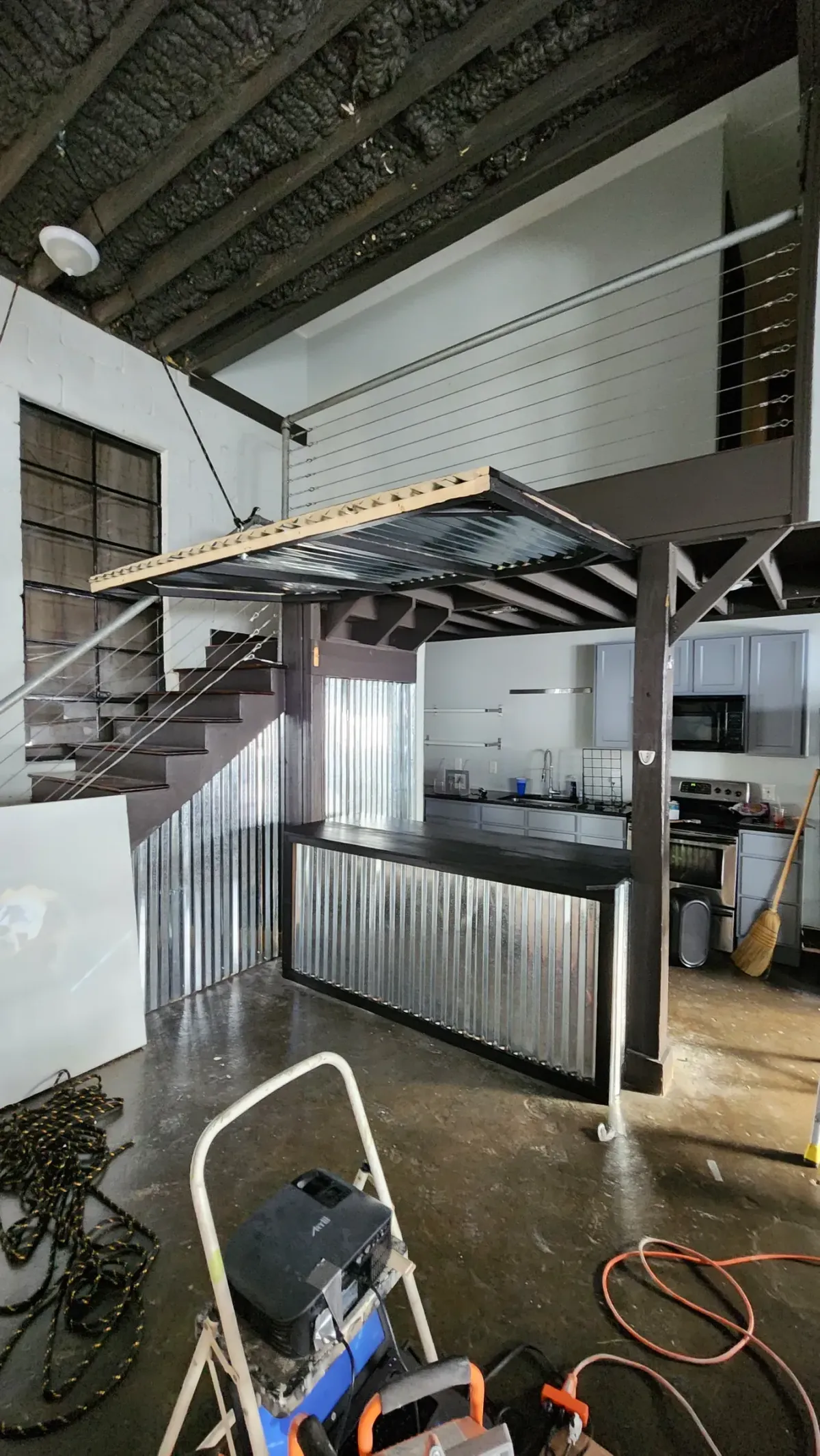 Steel mezzanine. Platform, stair stringers, and corrugated bar face
