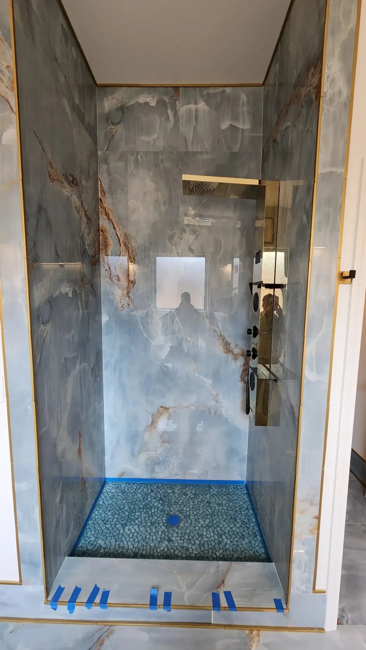 Metal trim and transitions. Brass profiles instead of caulk joints at every change of plane