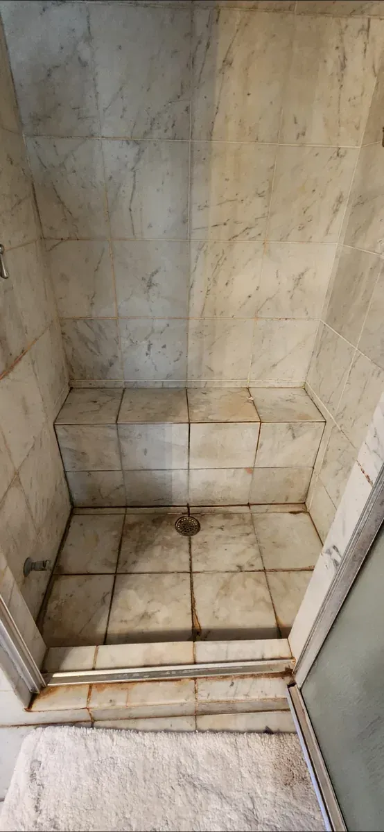 Dated Buckhead condo shower before demolition