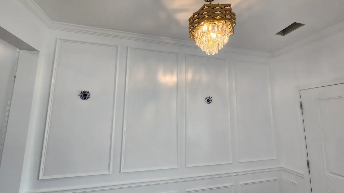 Wall panel moulding with chandelier in a formal room
