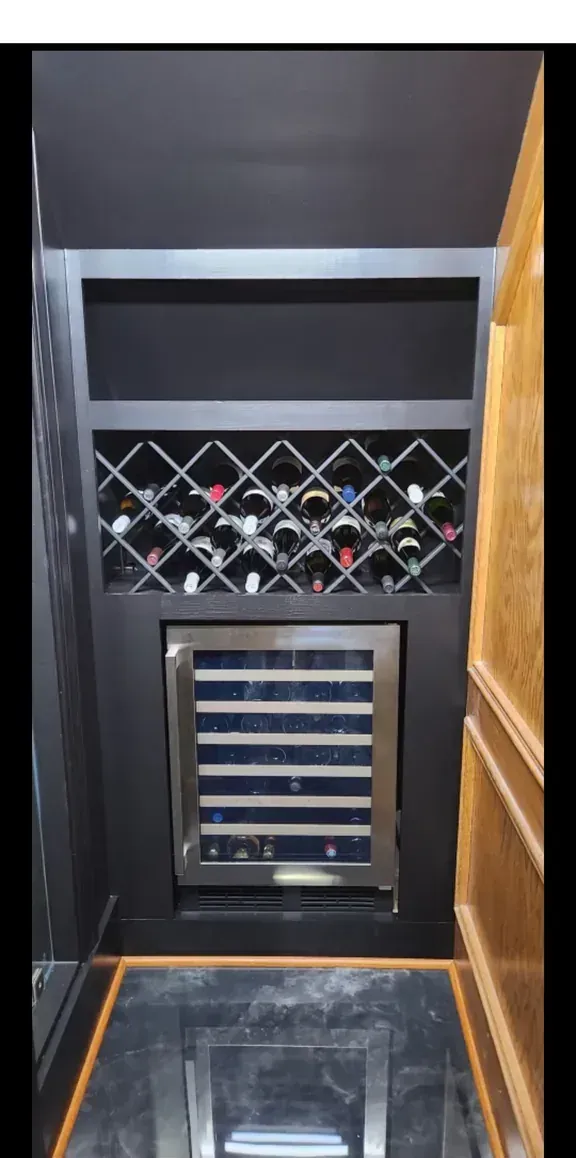 Finished custom wine cellar with diagonal lattice racking and a wine refrigerator