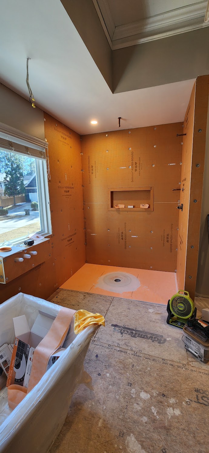 The same shower mid build, waterproof membrane on the walls and pan, niche framed