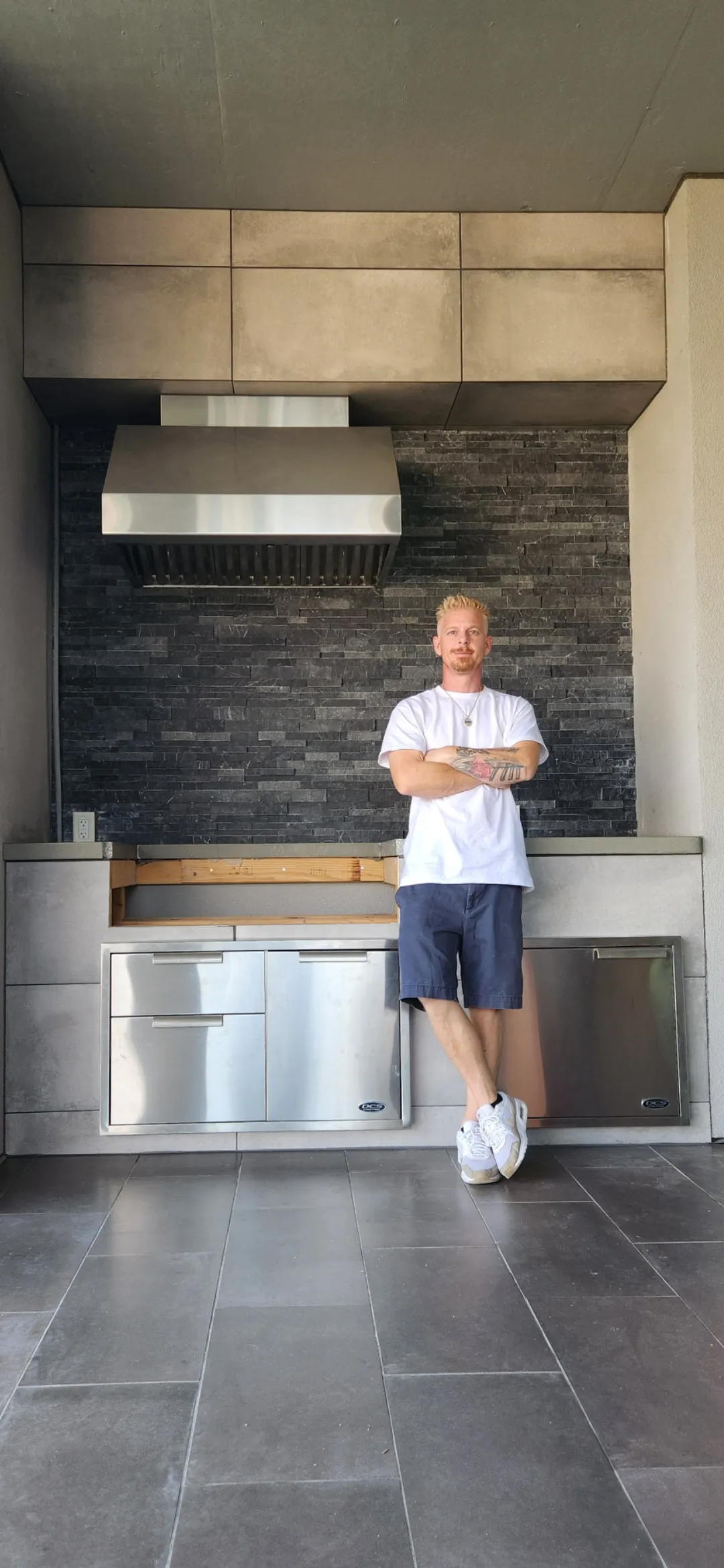 Erich Ingram, owner of Briarcliff Remodeling, standing at a finished outdoor kitchen build