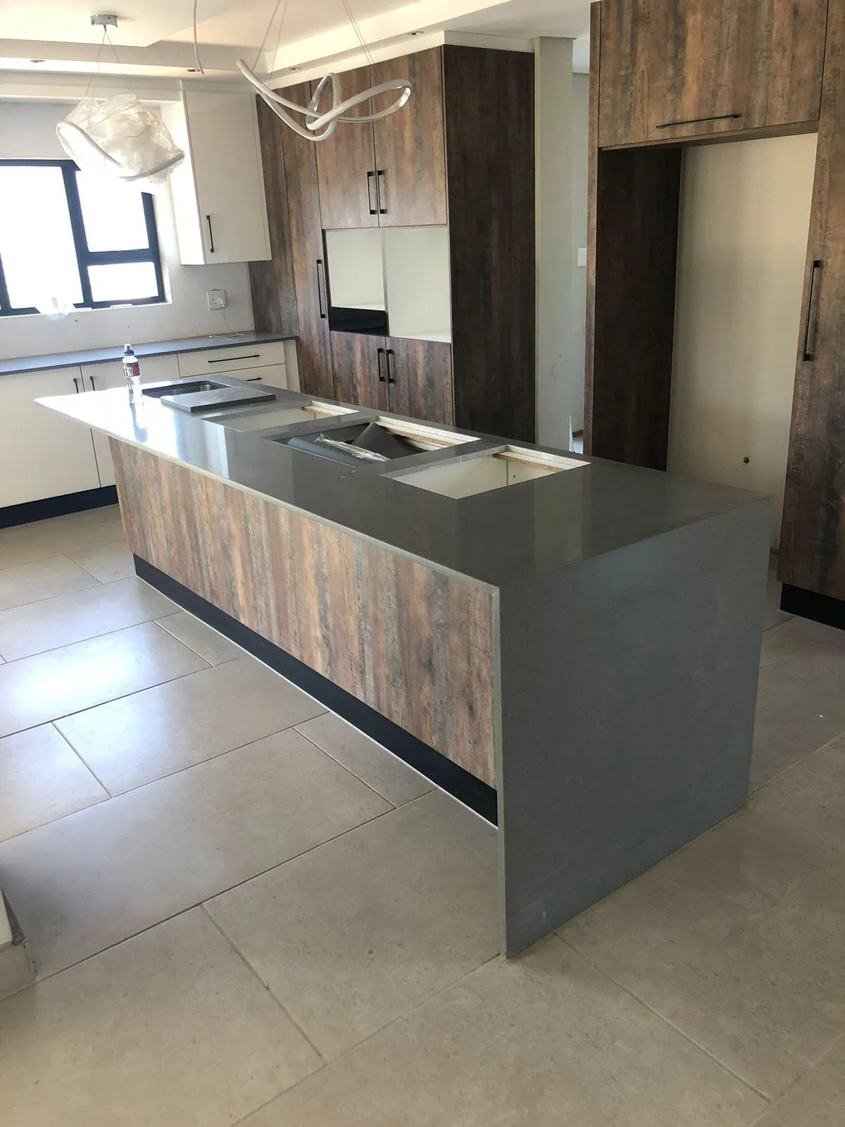Kitchen cupboard design featuring chair space under counter.