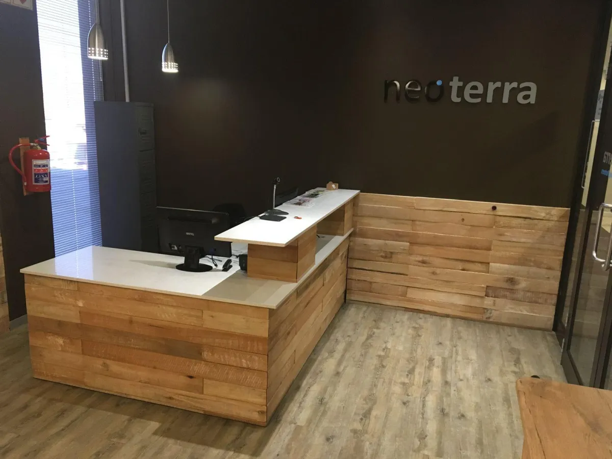 Wooden shop counter with white melamine countertops and display space.