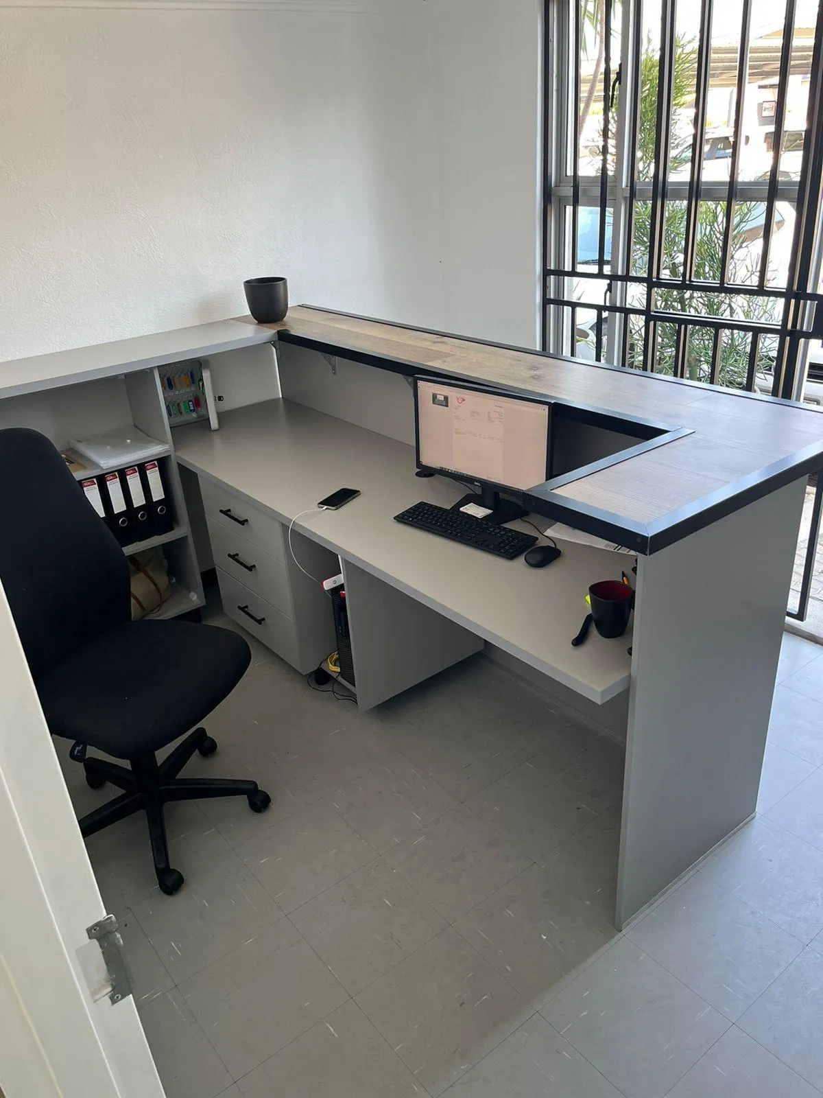 Reception desk with built-in filing cabinets.